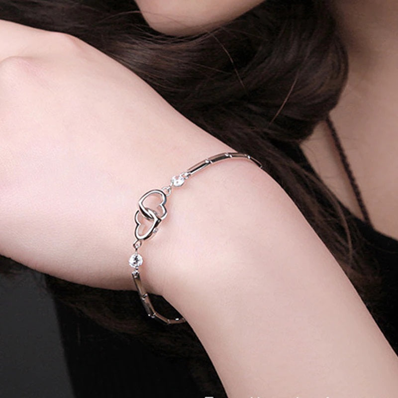 Matching mother daughter bracelet — interlocking double-heart bracelet worn on a wrist