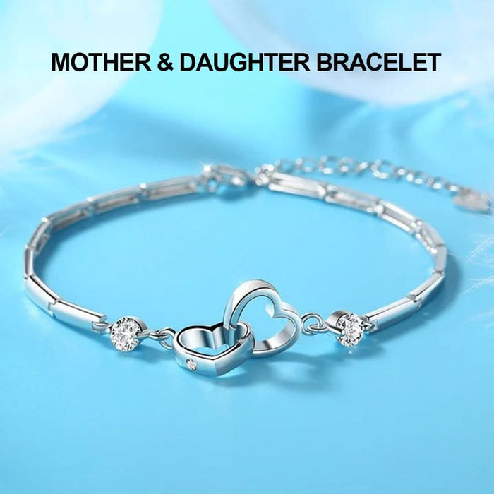 Mother & Daughter Hearts Bracelet — two interlocked hearts with cubic zirconia