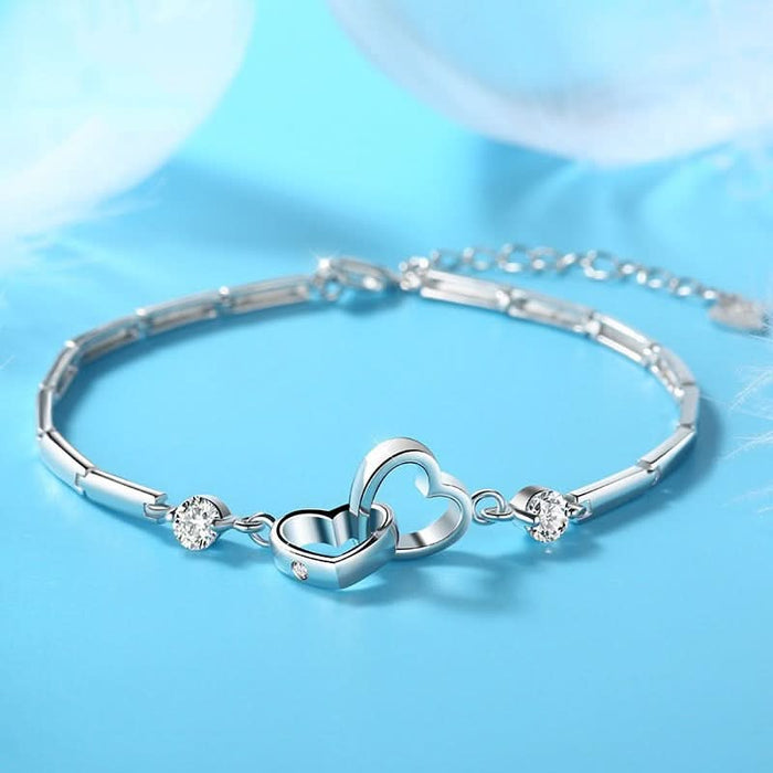 Soul Sister Heart Bracelet — two interlocked hearts, 100K+ sold